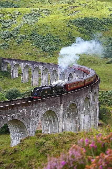 Jacobite steam train crossing the Glenfinnan Viaduct in the Scottish Highlands