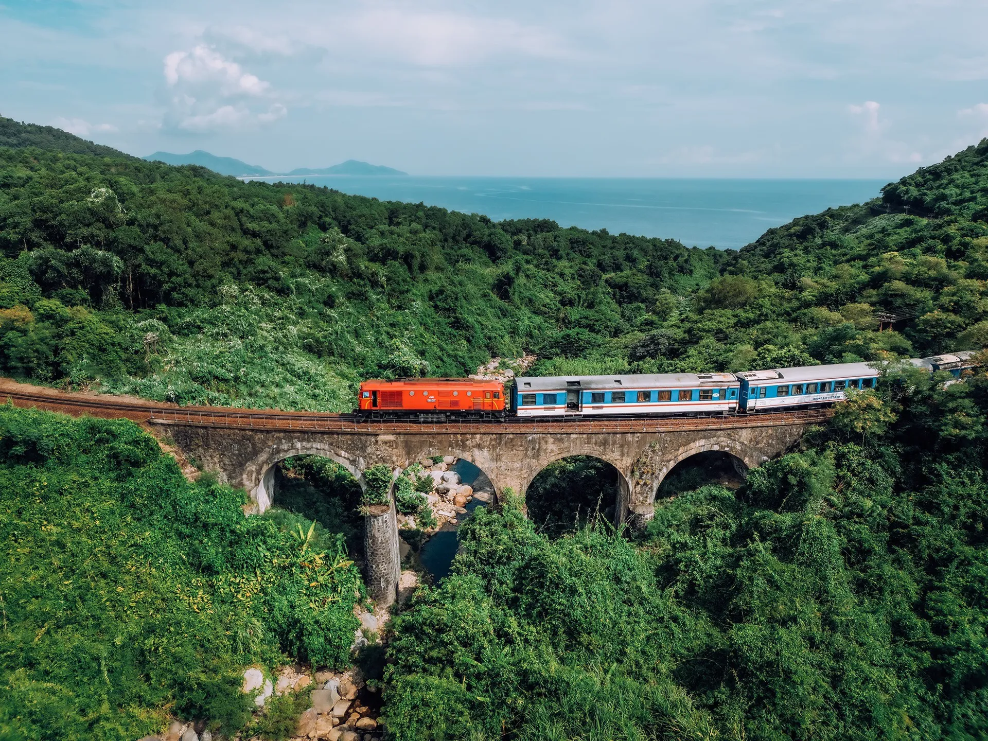 Vietnamese Reunification Express train running along the scenic coast