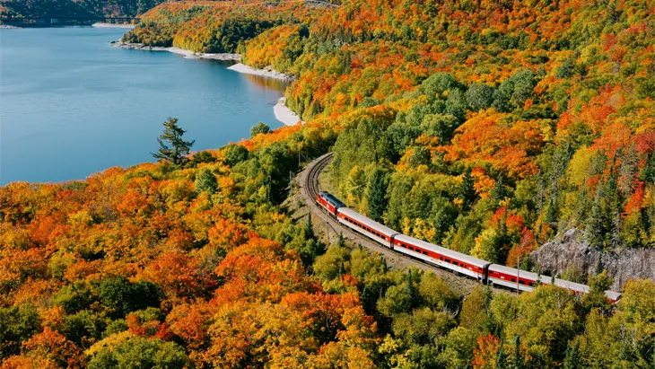 Stunning aerial view of a train traveling through dramatic mountain scenery
